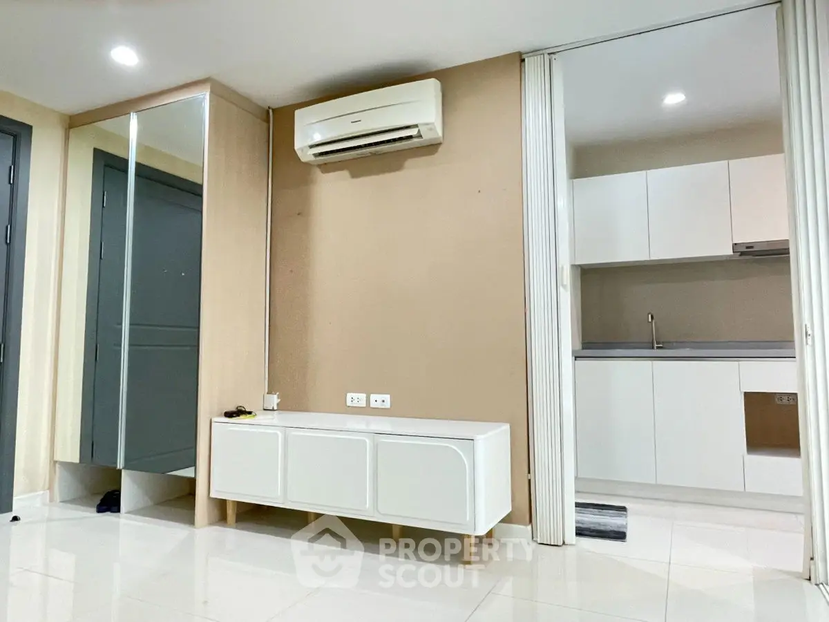 Modern apartment interior with sleek kitchen and air-conditioned living space