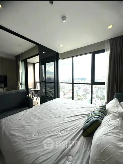 Luxurious bedroom with stunning city view and spacious balcony access