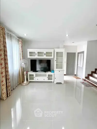 Spacious living room with modern entertainment center and elegant decor