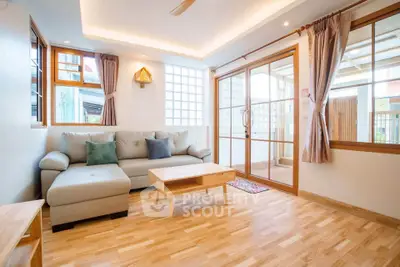 Bright and spacious living room with modern decor and large windows