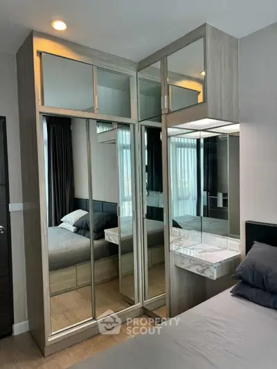 Modern bedroom with mirrored wardrobe and stylish decor