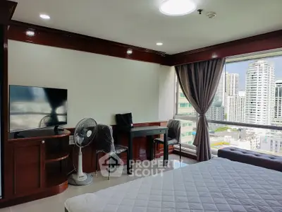 Spacious bedroom with city view, featuring modern furniture and large windows for natural light.