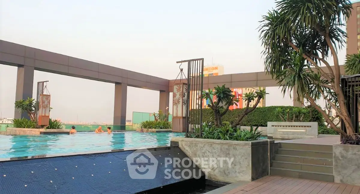 Luxurious rooftop pool with lush greenery and modern design, perfect for relaxation and city views.