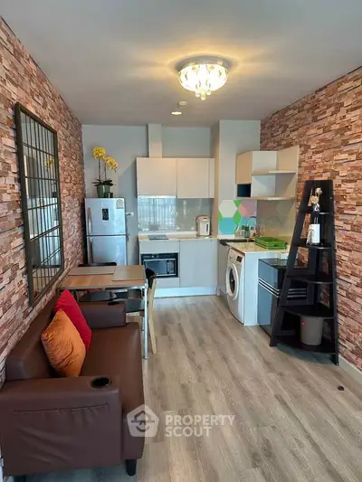Modern open-layout kitchen with stylish brick walls and cozy living area.