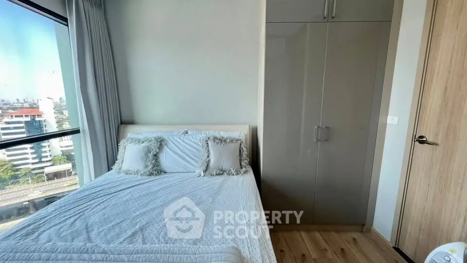 Cozy bedroom with city view and modern wardrobe