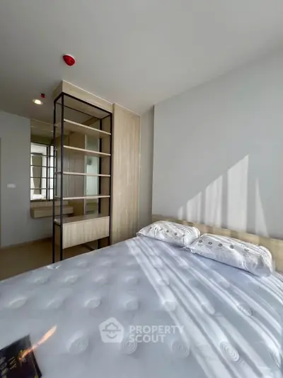 Bright and modern bedroom with stylish decor and ample natural light.
