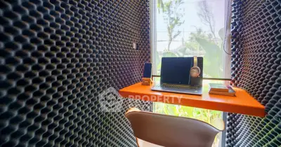 Modern study nook with soundproofing and natural light, ideal for focused work.