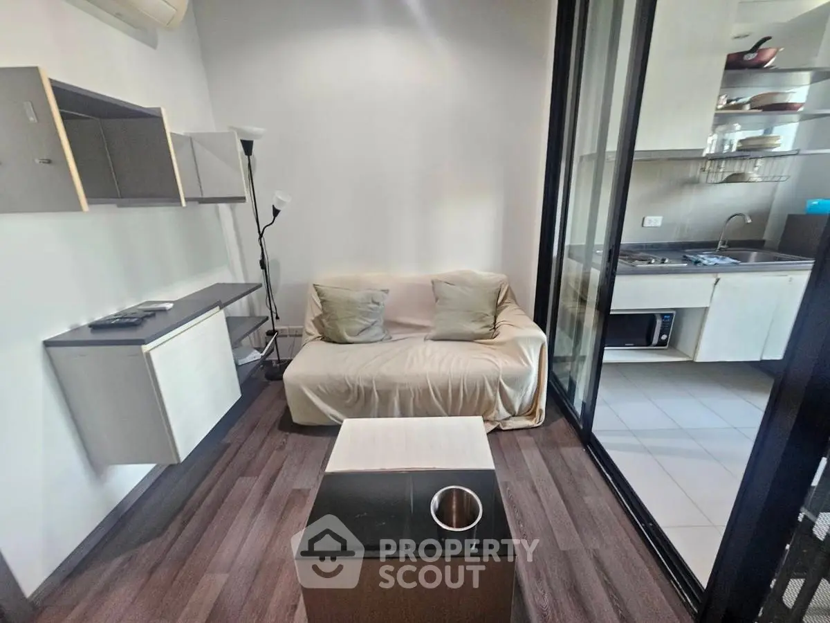 Modern compact living room with sleek kitchen and cozy sofa