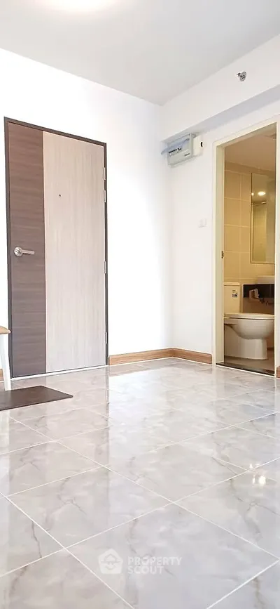 Modern apartment interior with tiled flooring and bathroom view