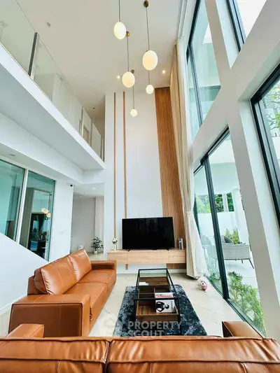 Luxurious modern living room with high ceilings and large windows