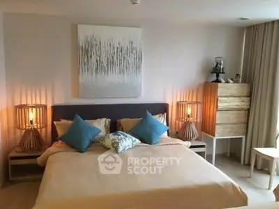 Elegant bedroom with modern decor and cozy lighting in a stylish apartment.