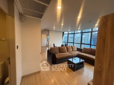 Spacious modern living room with large windows and city view