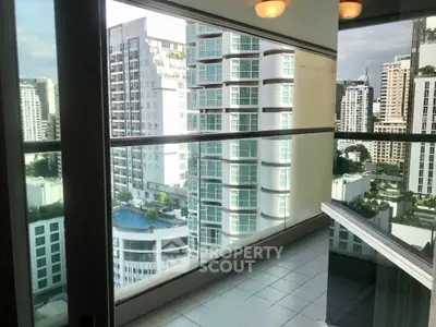 Stunning high-rise balcony with panoramic city views and modern glass railing.
