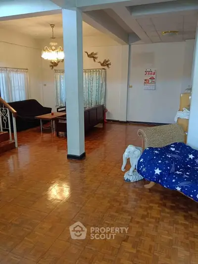 Spacious living room with wooden flooring and elegant decor