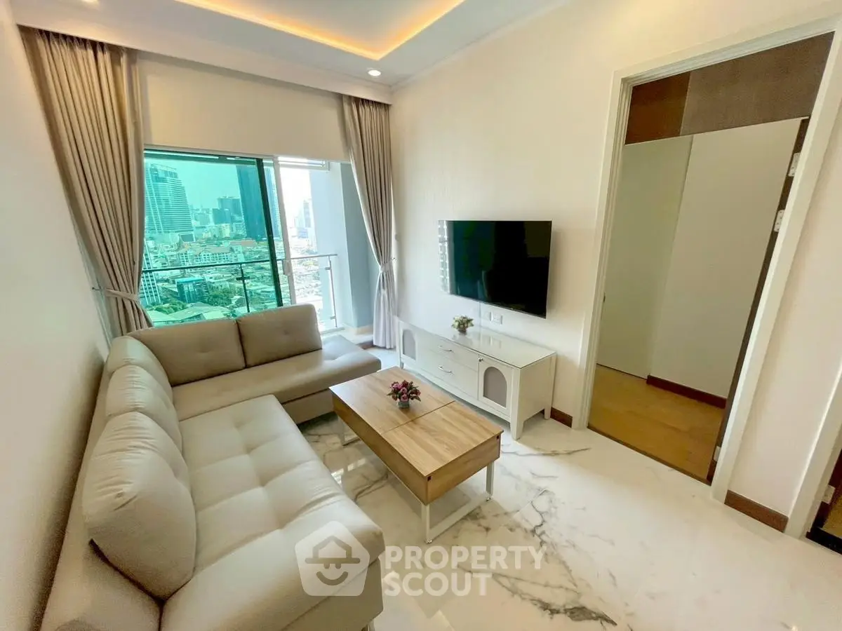 Modern living room with city view, elegant sofa, and sleek TV setup.
