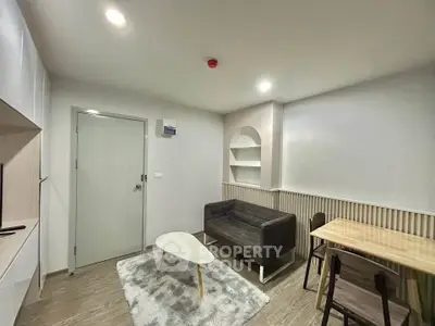 Modern living room with cozy sofa, stylish table, and elegant decor in a contemporary apartment.