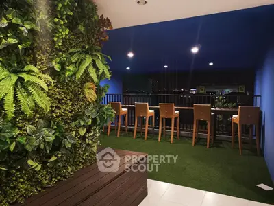 Stylish balcony with lush vertical garden and city view, perfect for relaxation and entertaining.