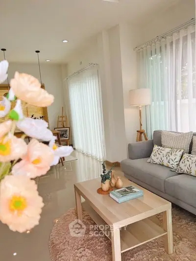 Bright and airy living room with modern decor and large windows.