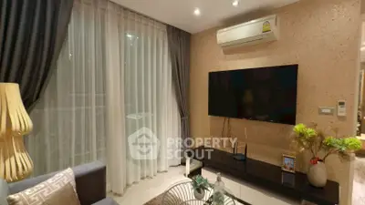 Modern living room with stylish decor, large TV, and elegant curtains in a cozy apartment.