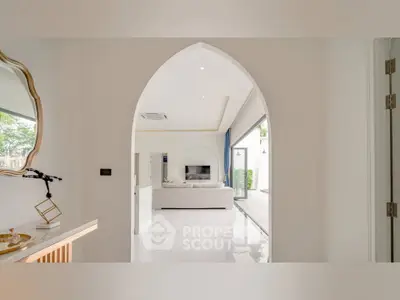 Elegant living room with archway entrance and modern decor