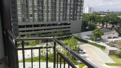 Spacious balcony with city view in modern apartment complex
