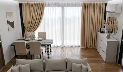 Elegant living room with dining area, featuring modern furniture and large windows with beige curtains.