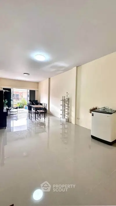 Spacious living area with modern dining setup and natural light