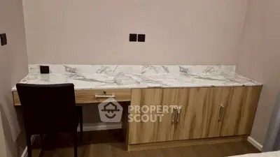 Modern study area with marble desk and wooden cabinets in a stylish home interior.