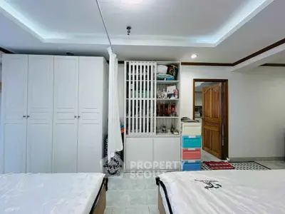 Spacious bedroom with modern storage solutions and elegant decor
