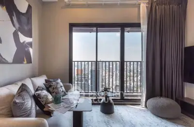 Stylish living room with city view, modern decor, and cozy seating area.