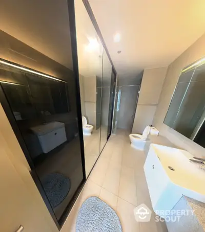 Modern bathroom with sleek design and large mirrors