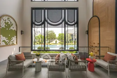 Luxurious living room with elegant decor and stunning garden view through large windows.