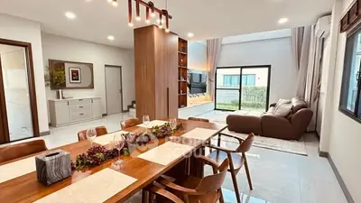 Spacious modern living and dining area with elegant decor and natural light.