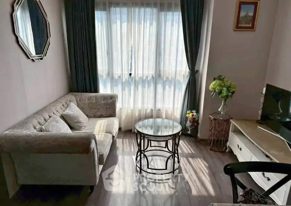 Cozy living room with elegant decor and natural light, featuring a plush sofa and stylish coffee table.