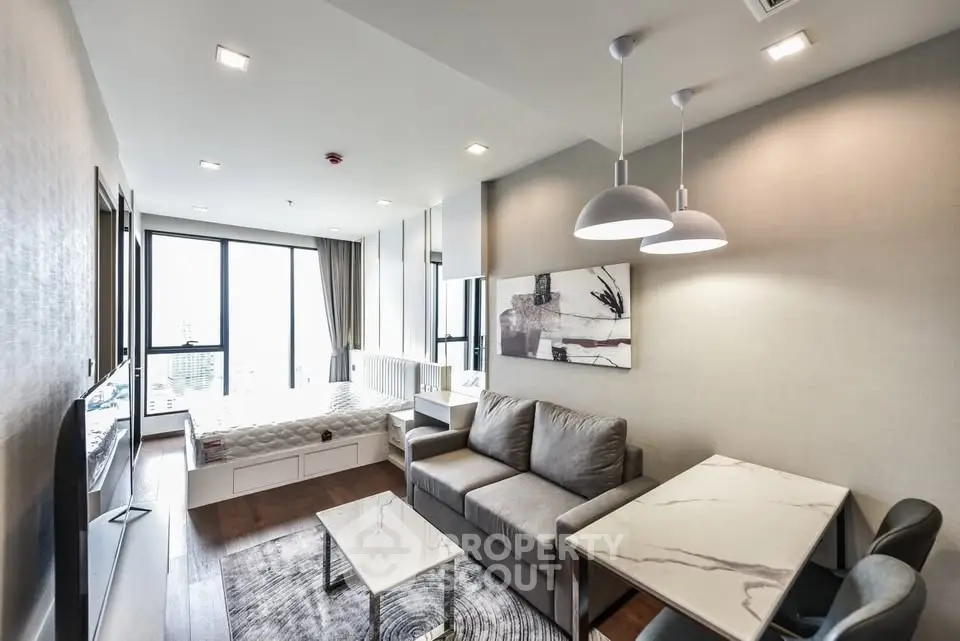 Modern living room with stylish decor and large windows offering city views