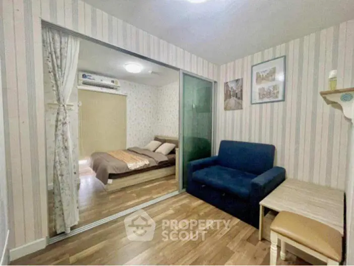 Cozy bedroom with sliding glass doors and stylish decor in modern apartment.