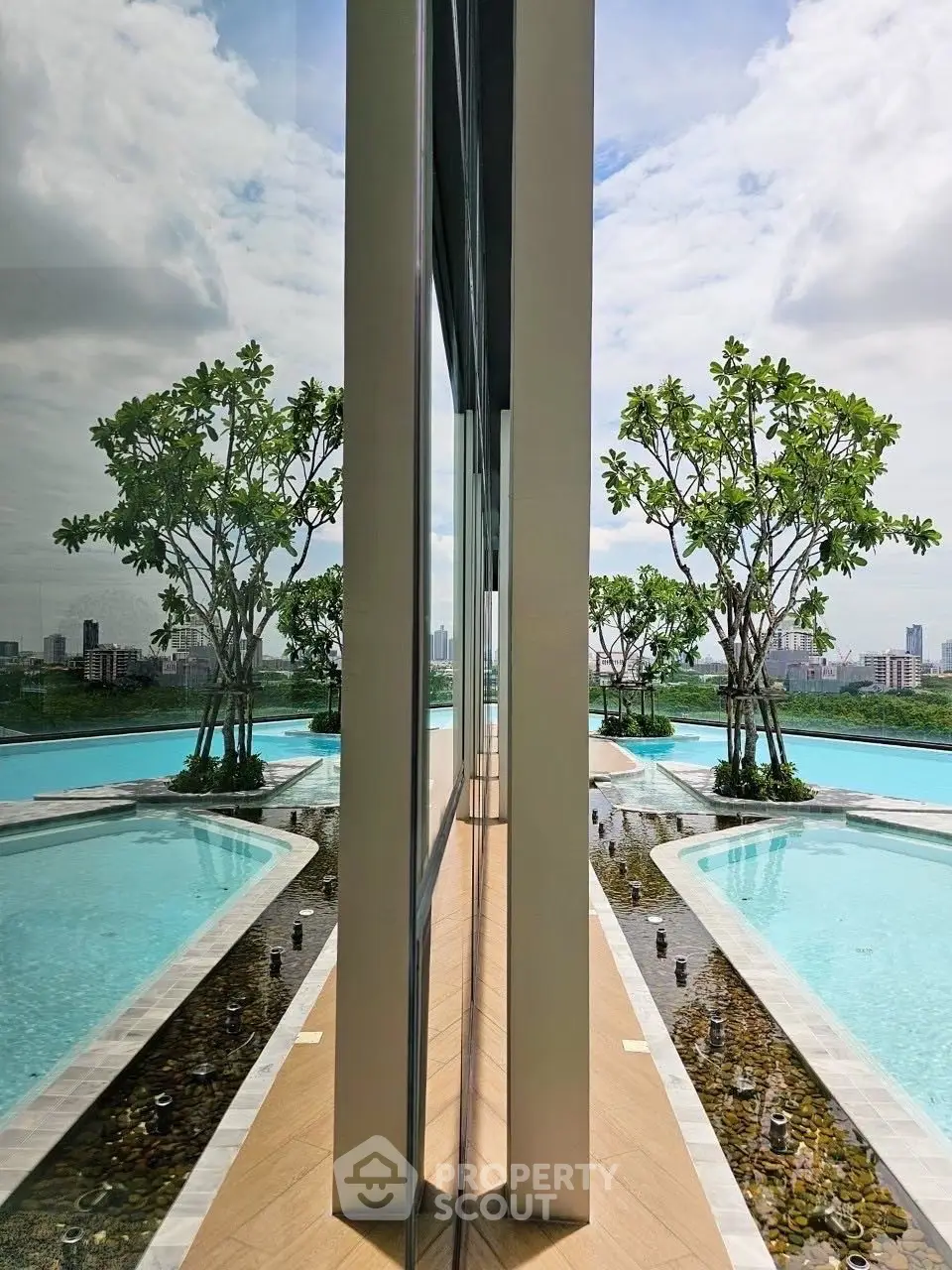 Luxurious rooftop pool with stunning city skyline view and modern design.