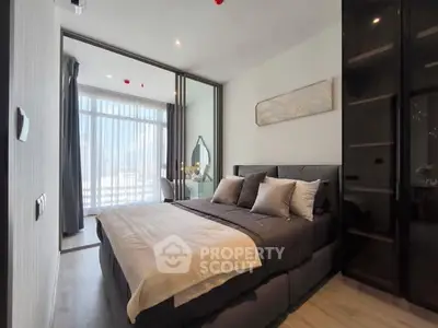 Modern bedroom with stylish decor and large windows for natural light.