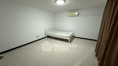 Spacious minimalist bedroom with air conditioning and tiled flooring