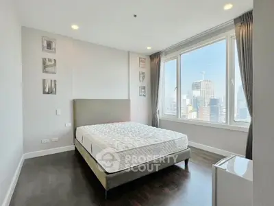 Spacious bedroom with city view and modern decor