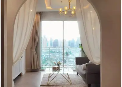Elegant living room with city view, modern decor, and large windows for natural light.
