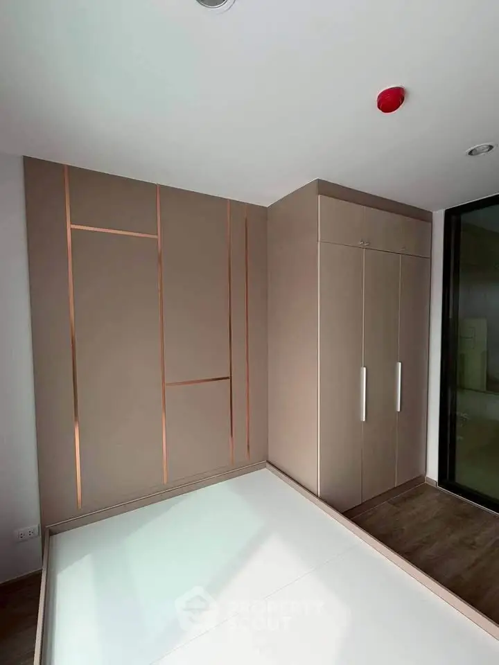 Modern bedroom with sleek built-in wardrobe and minimalist design