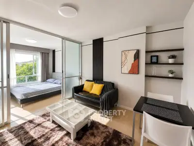 Modern studio apartment with open layout, featuring a cozy living area and bedroom with natural light.