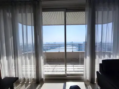 Stunning balcony view with ocean backdrop from a modern apartment.