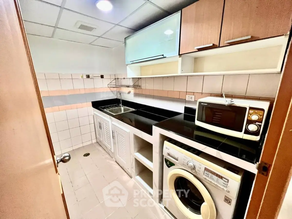 Compact kitchen with modern appliances and ample storage space