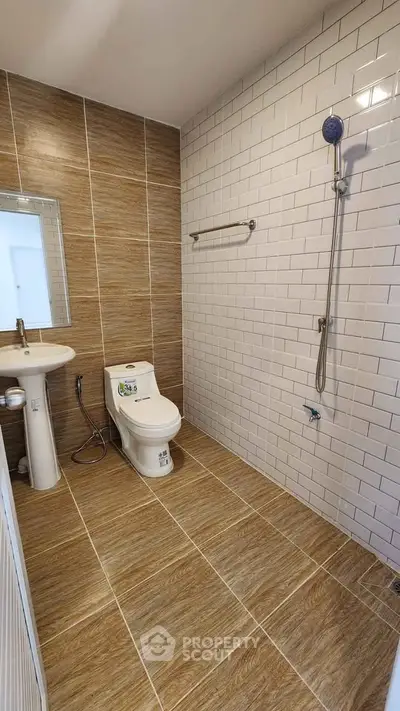 Modern bathroom with sleek tiles and contemporary fixtures in a stylish real estate property.