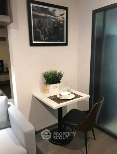 Cozy dining nook with modern decor and stylish seating in a compact living space.