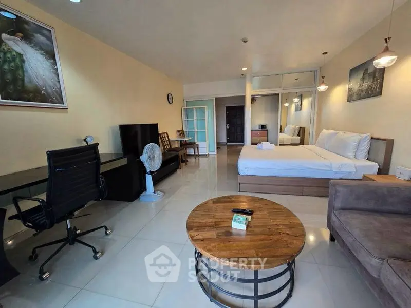 Spacious studio apartment with modern furnishings and open layout, ideal for urban living.