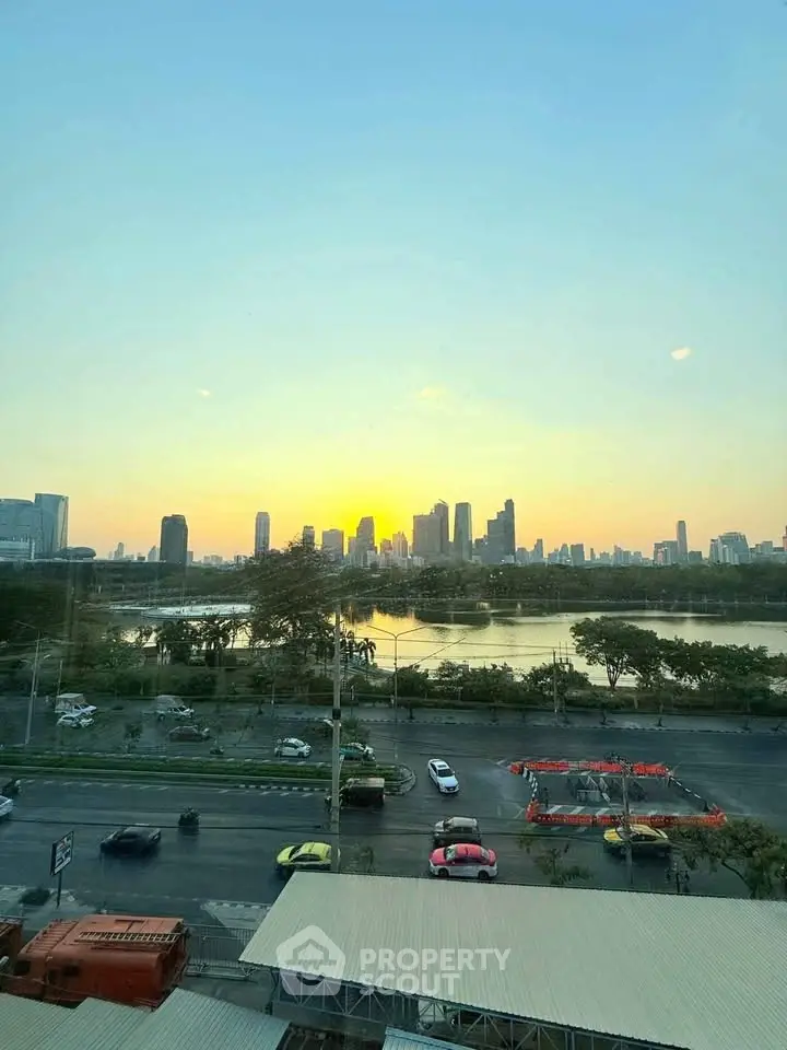 Stunning city skyline view at sunset from a high-rise building, showcasing urban living at its finest.