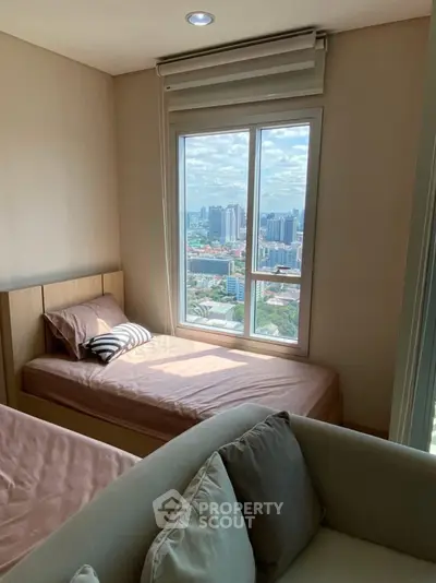 Cozy bedroom with city view, featuring twin beds and modern decor, perfect for urban living.